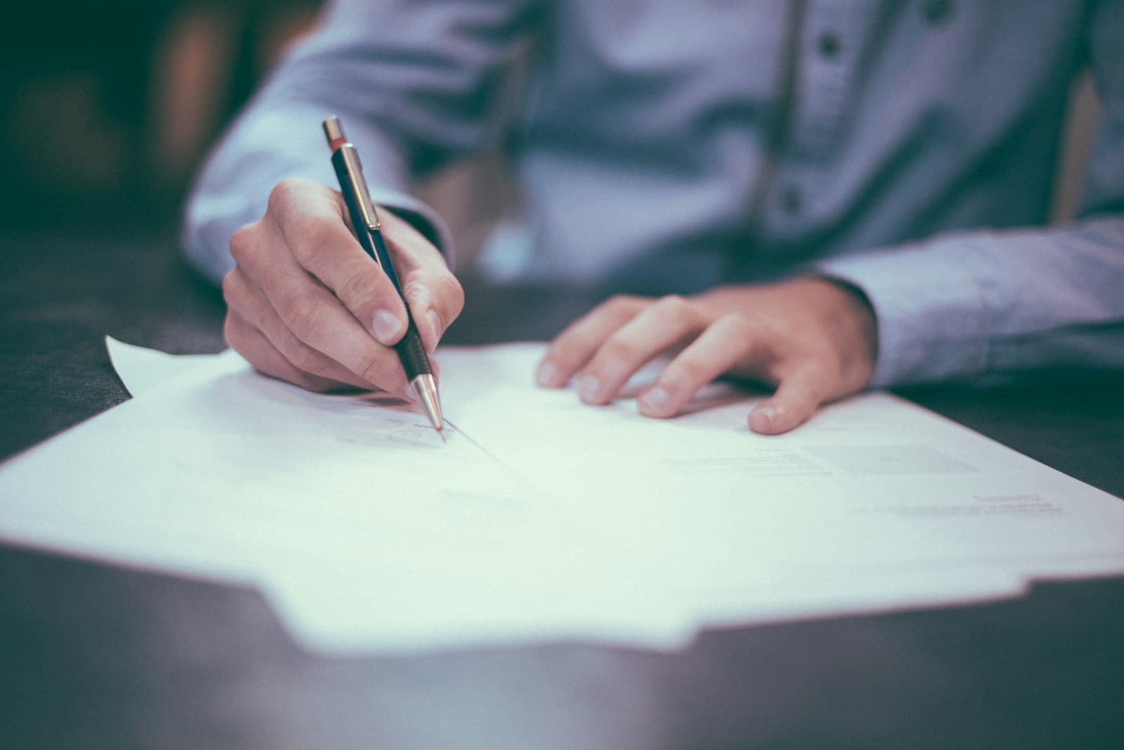 Reviewing and completing academic record paperwork by hand