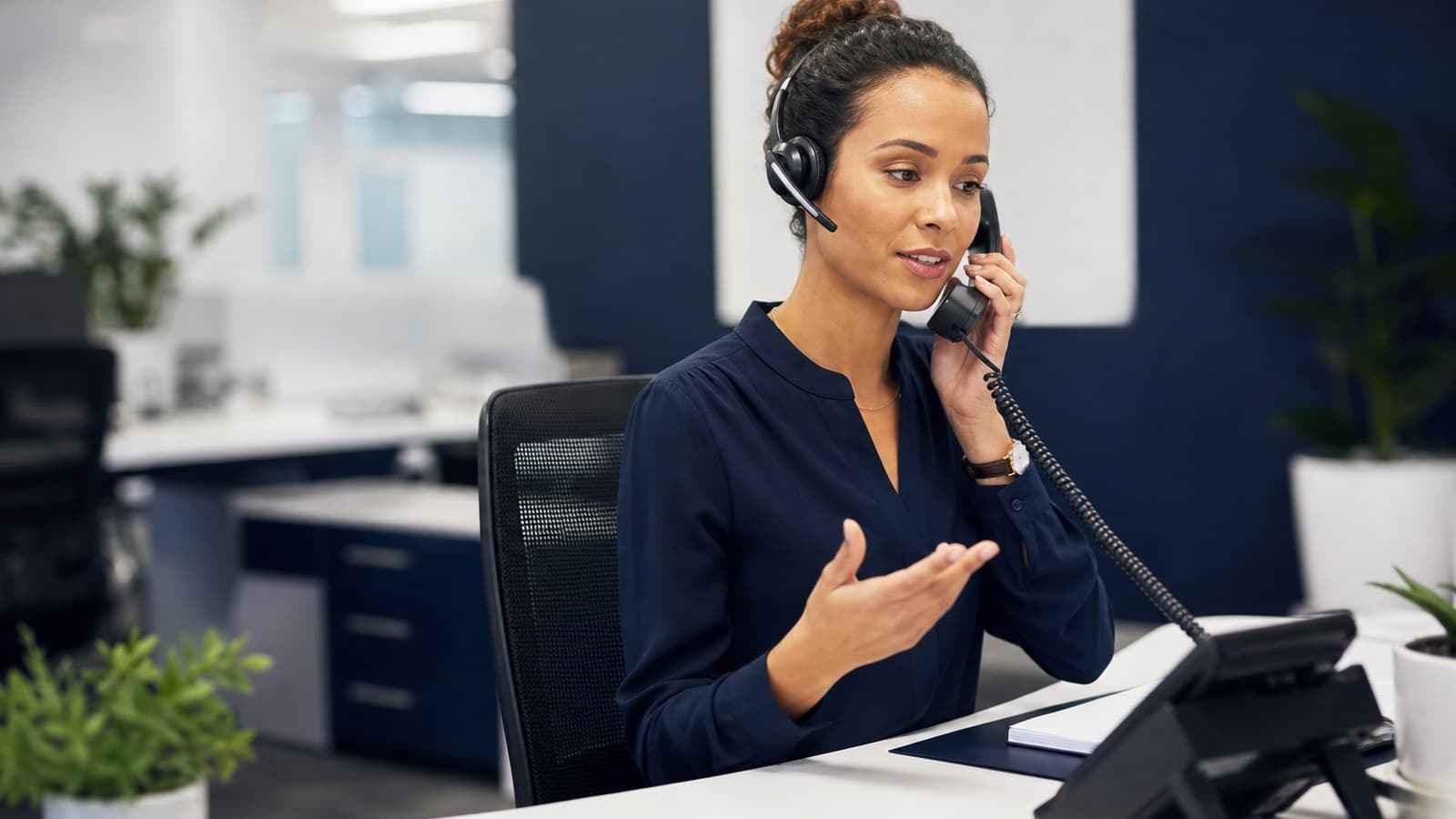 Business professional using over-the-phone interpreting services during a client call