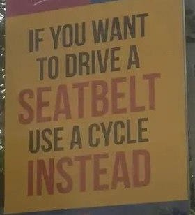 Traffic sign reading ‘If you want to drive a seatbelt use a cycle instead’